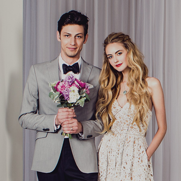 A bride with her groom holding flowers