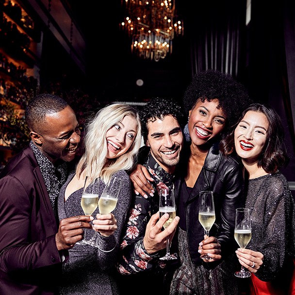 Group of men and women enjoying cocktails